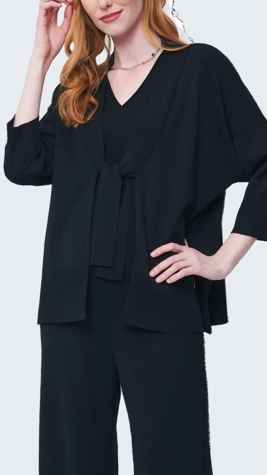 Woman wearing a black outfit with a plain background