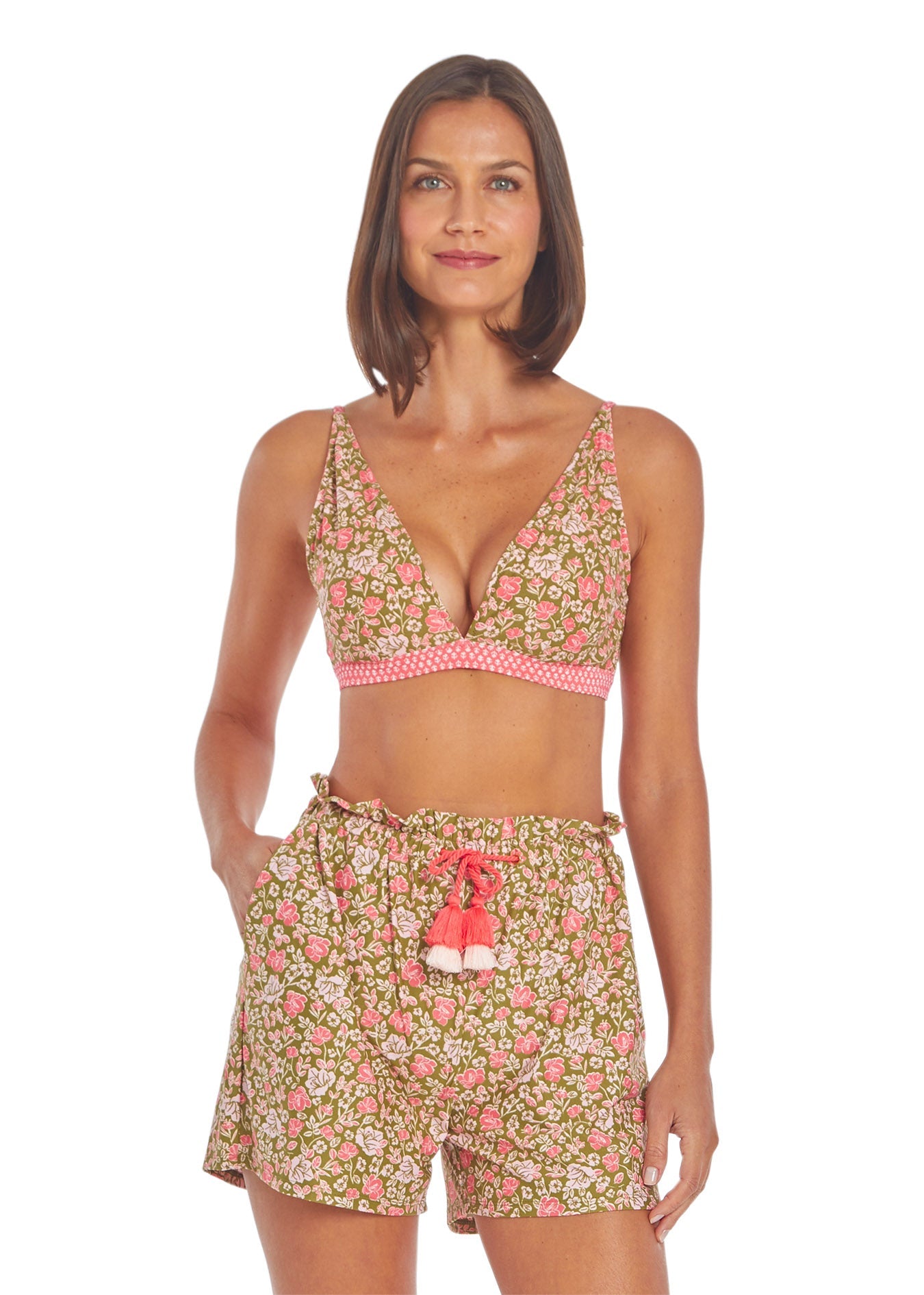 Woman wearing a floral two-piece set with a white background