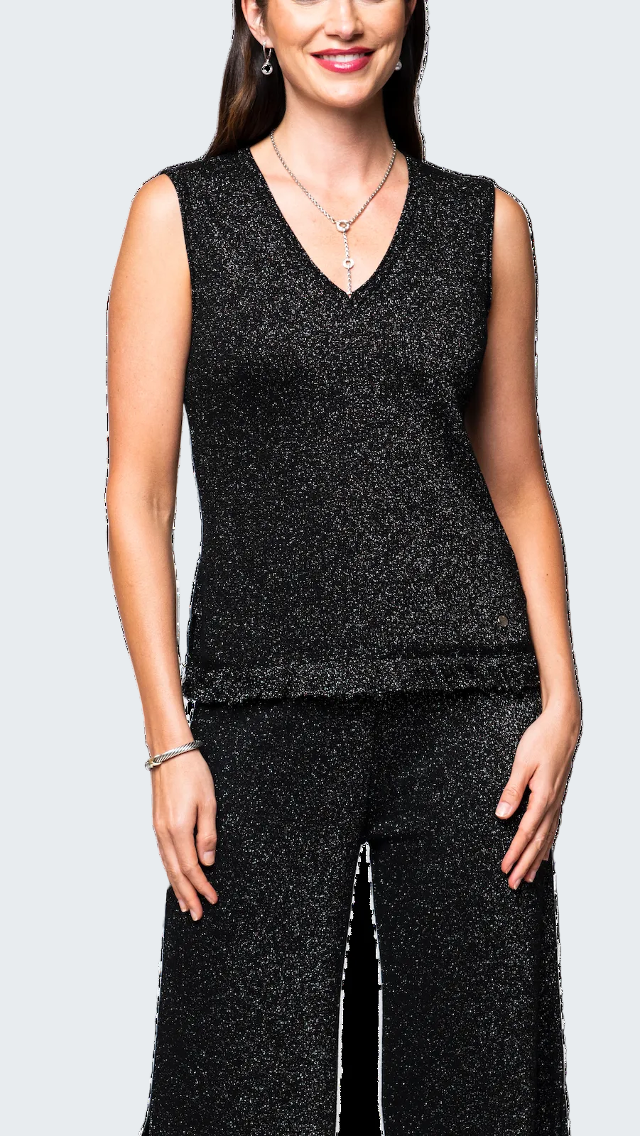 Woman wearing a black sleeveless top and pants set on a white background