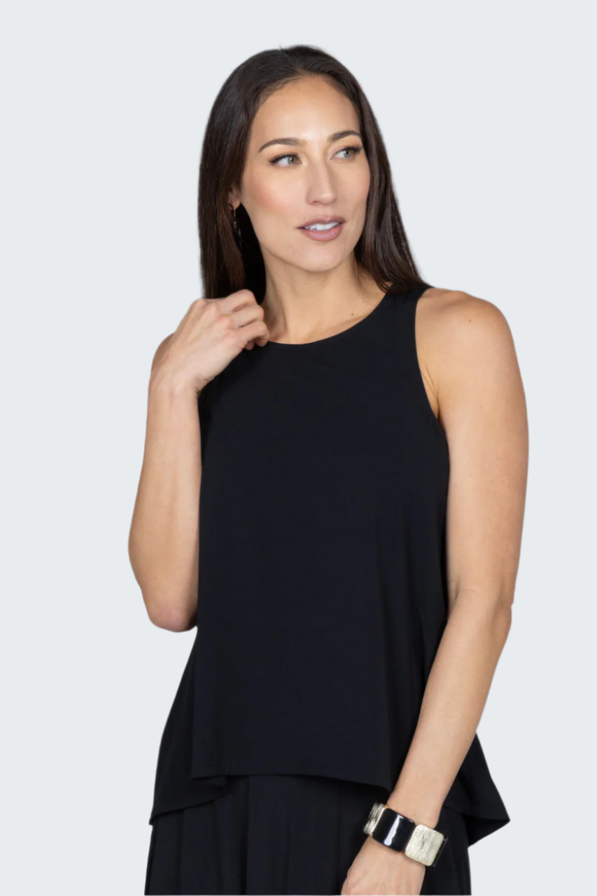 Woman wearing a black sleeveless top against a gray background