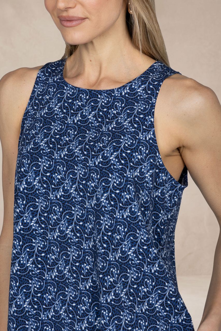 Woman wearing a blue floral dress against a beige background