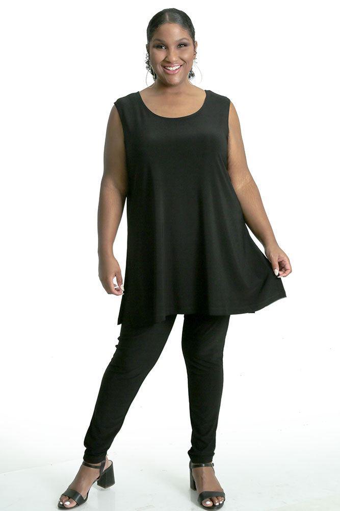 Woman wearing a black sleeveless top and pants on a white background