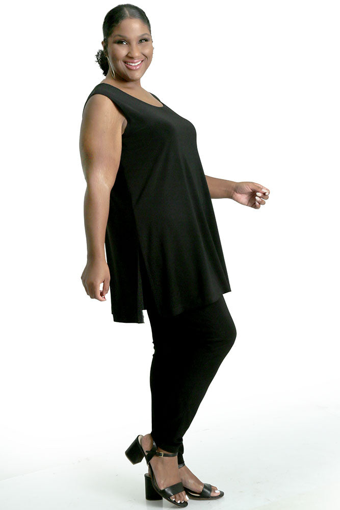 Woman wearing a black sleeveless top and pants on a white background