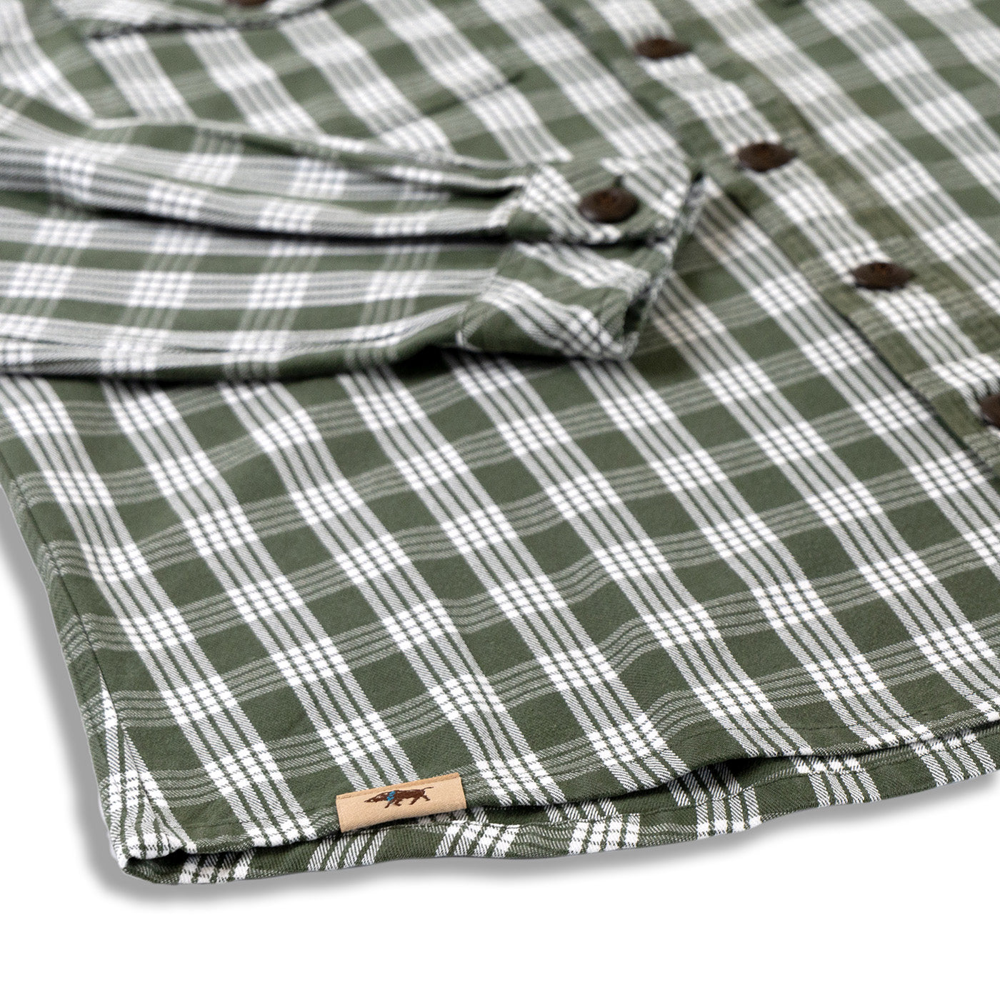 Folded green and white plaid shirt with a brand label on a white background