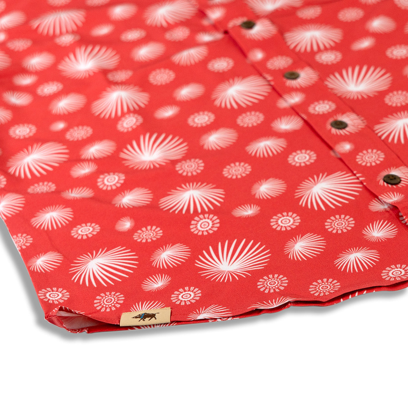 Red fabric with white floral pattern on a white background