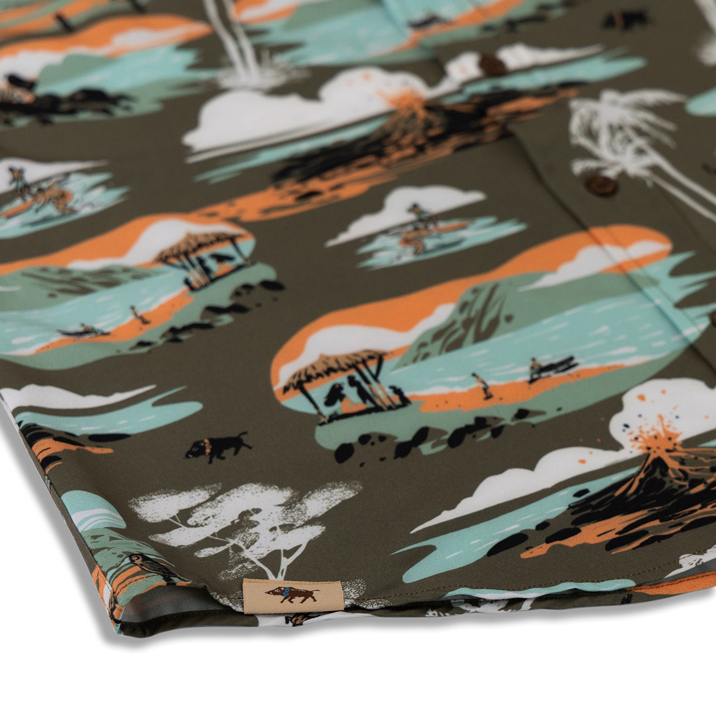 Folded fabric with a scenic pattern featuring trees, animals, and a sunset on a dark background.