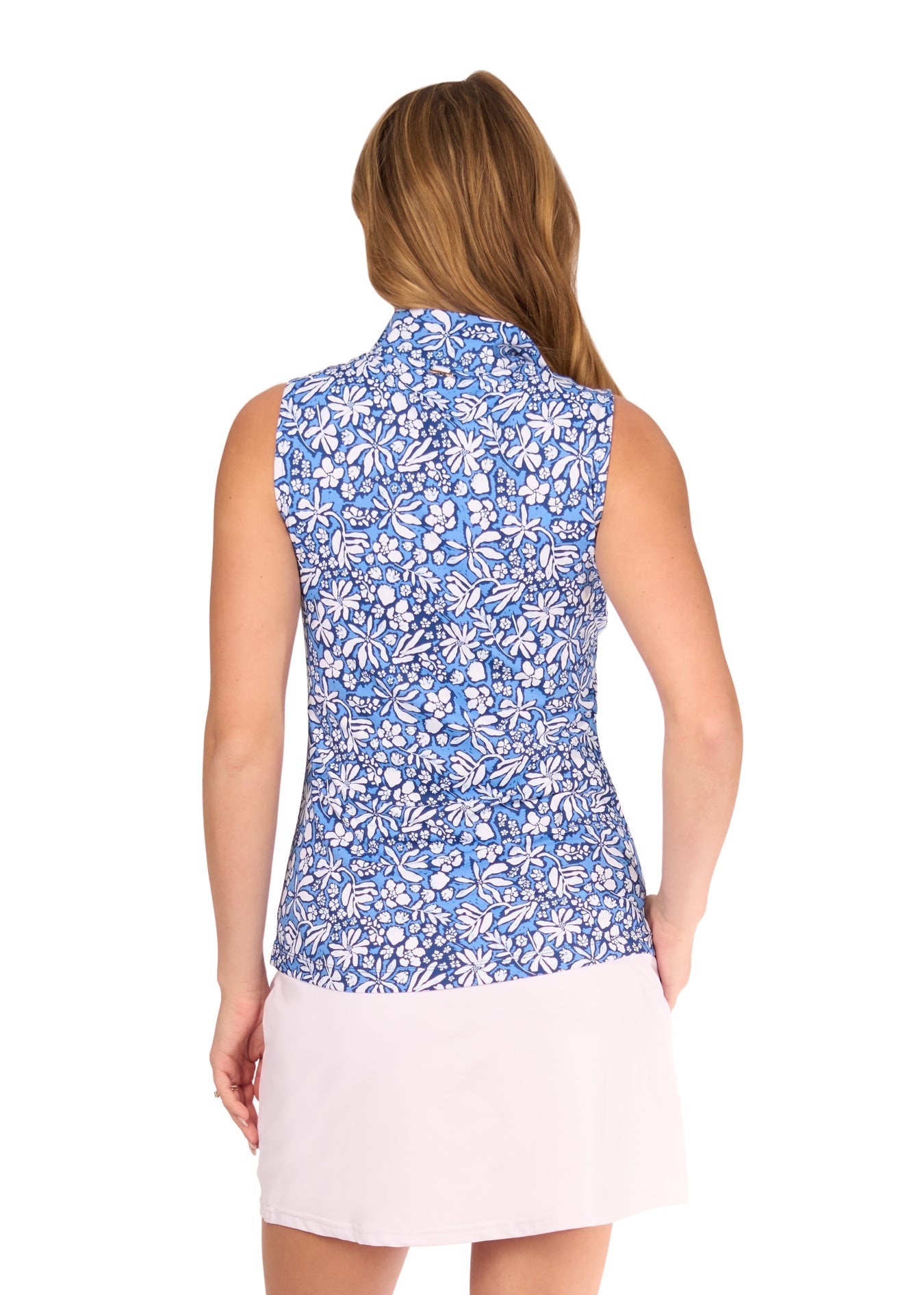 Woman wearing a blue floral sleeveless top with a white background
