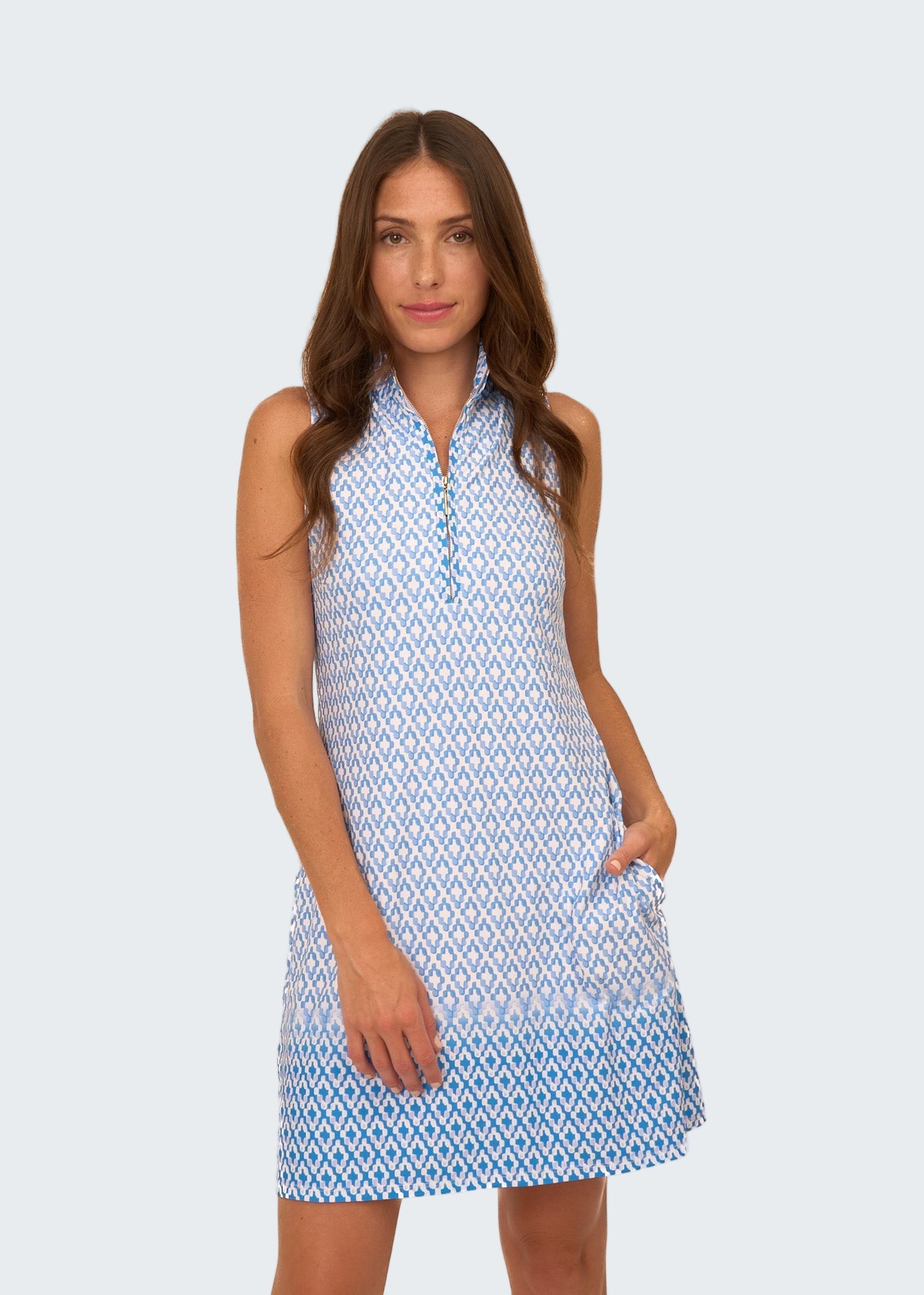 Woman wearing a blue and white patterned dress on a white background