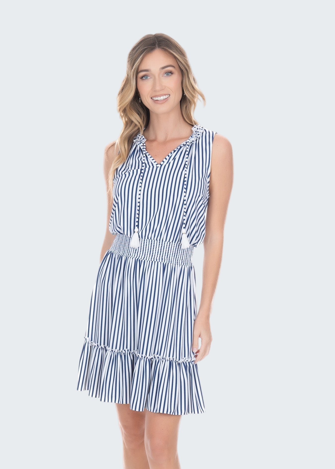 Woman wearing a blue and white striped dress on a white background