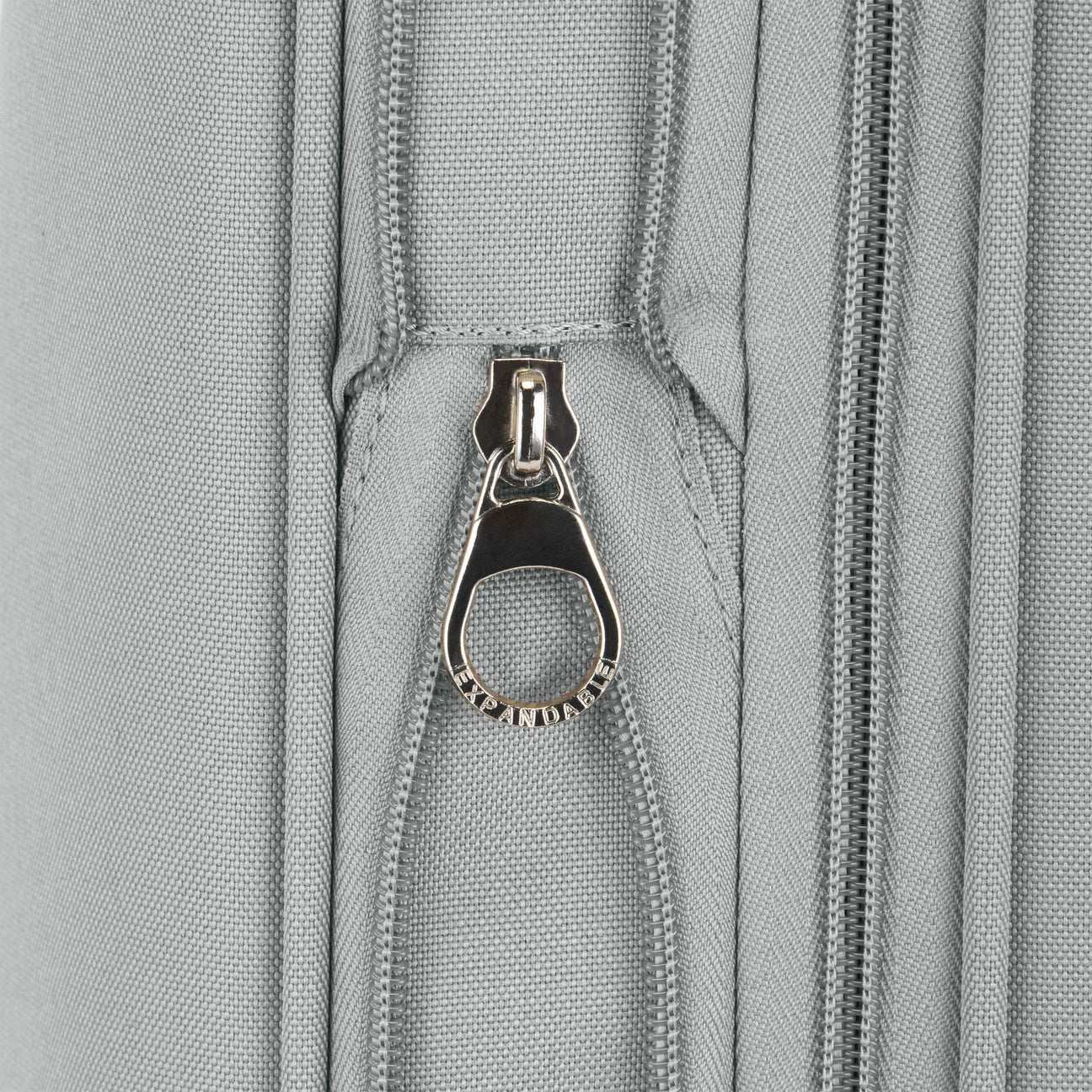 Close-up of a zipper on a gray fabric surface