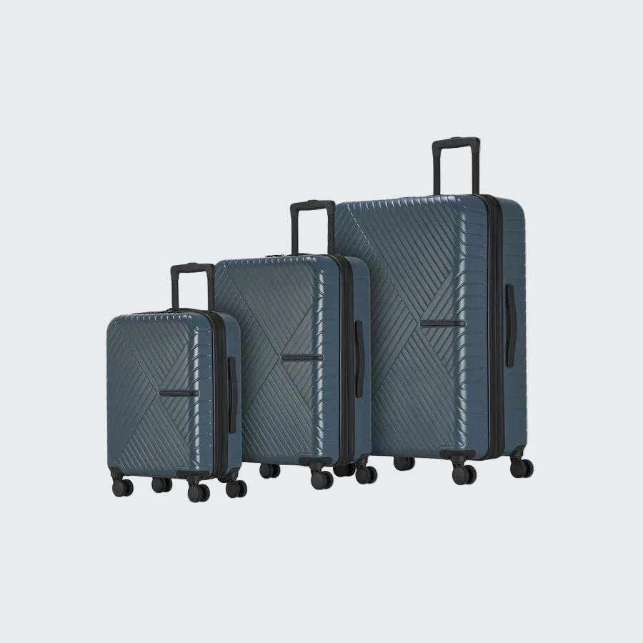 Set of three blue suitcases with a geometric pattern on a white background