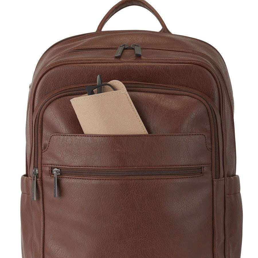 Brown leather backpack with a pen and paper inside on a white background