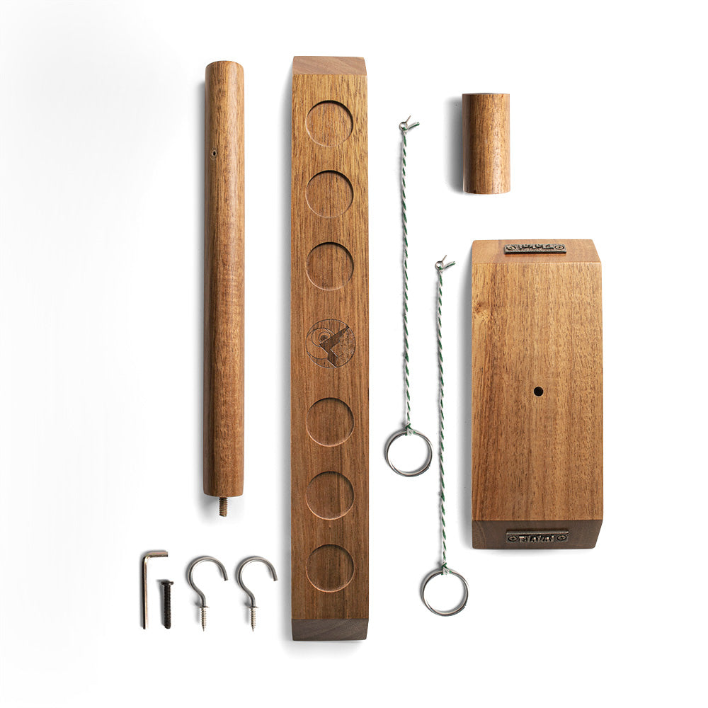 Wooden hanging kitchen organizer with various hooks on a white background