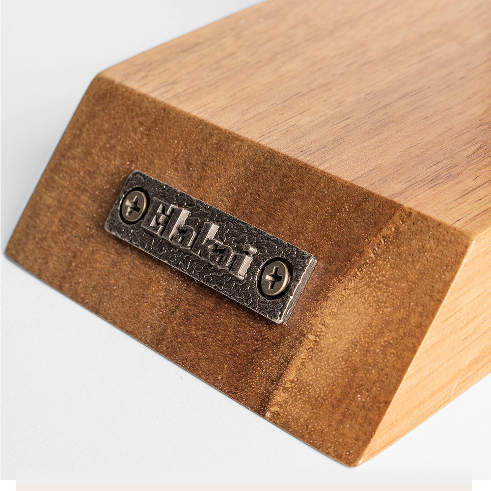 Wooden block with a metal label on a white background
