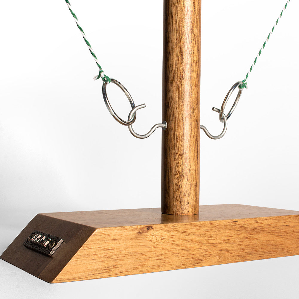 Wooden swing set with a platform and hooks on a white background
