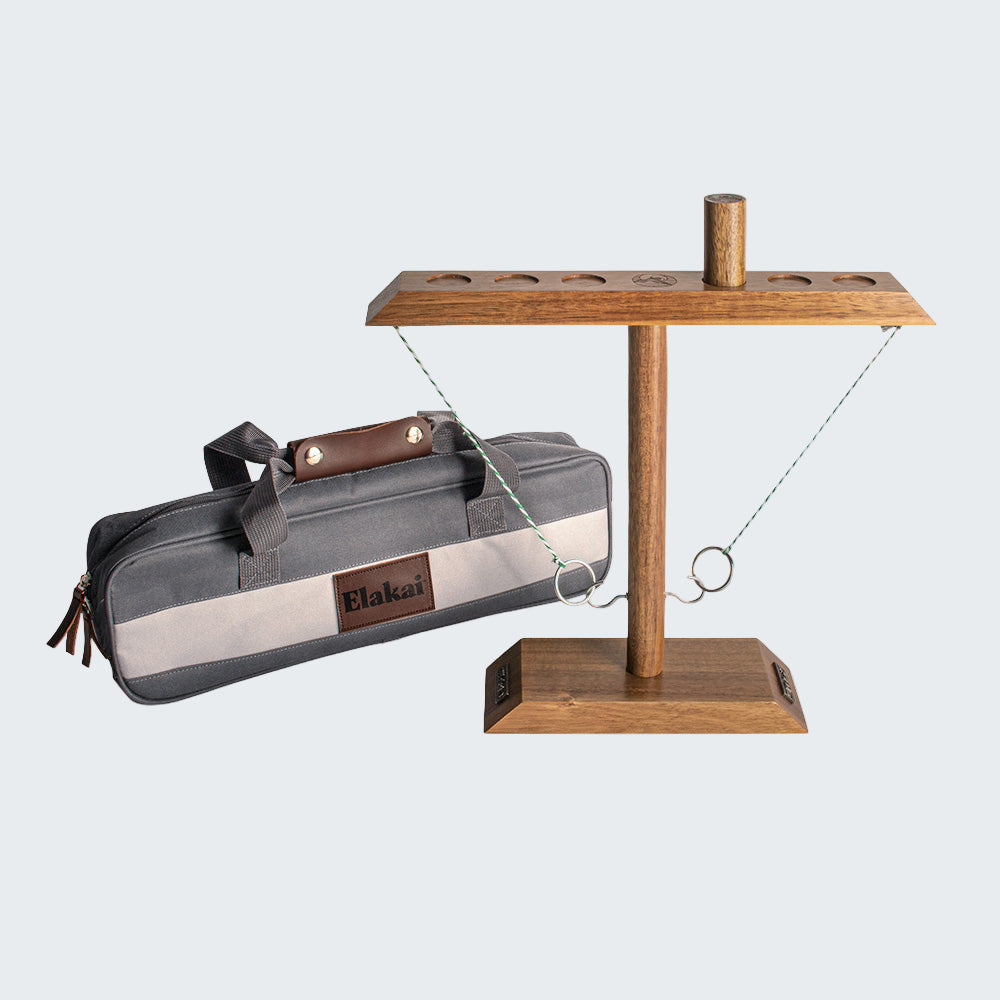 Wooden cat tree with hanging gray bag on a white background