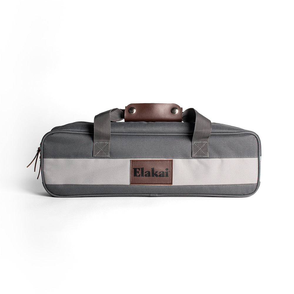 Gray and white bag with brown leather patch and 'Elakai' branding on a white background
