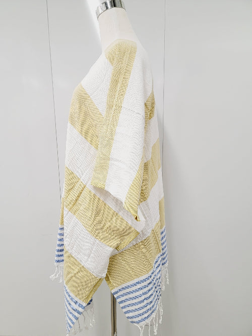 Mannequin wearing a yellow and white striped towel with blue accents on a plain background