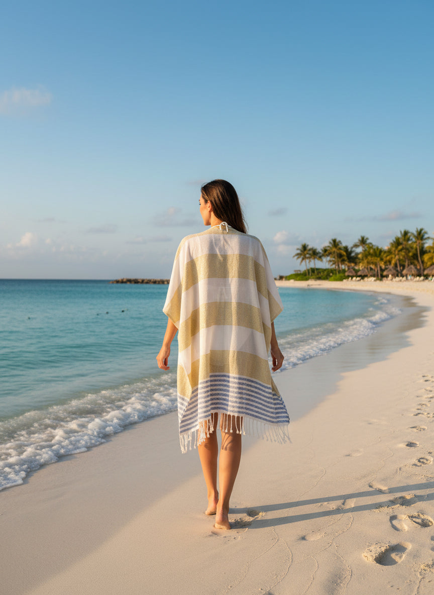 Mannequin wearing a striped yellow and white poncho with blue accents on a white background