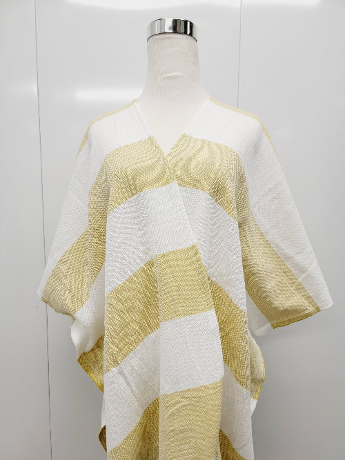 Mannequin wearing a yellow and white striped poncho against a white background
