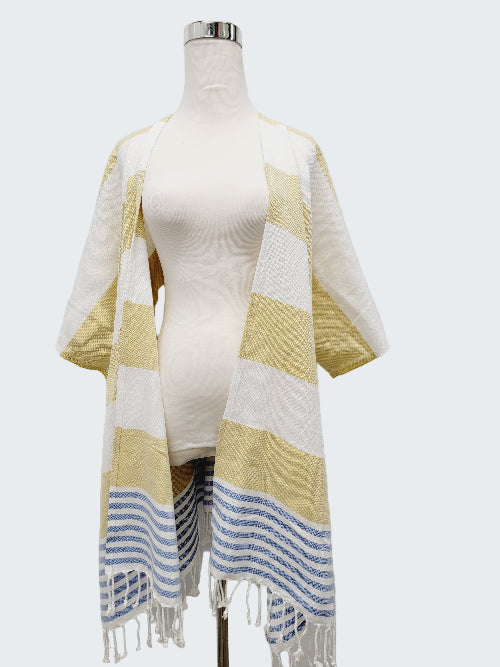 Mannequin wearing a yellow and white striped towel with blue accents on a white background