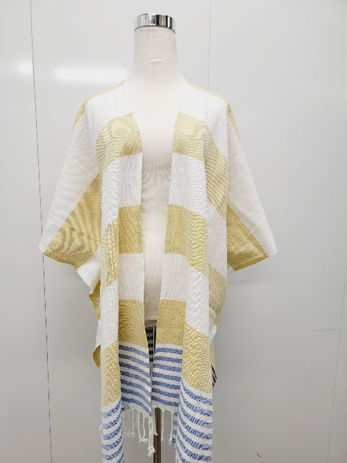 Mannequin wearing a yellow and white striped cover-up with fringe on a white background