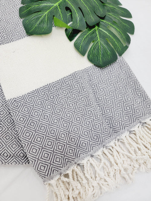 Textile with geometric pattern and fringes on a white background