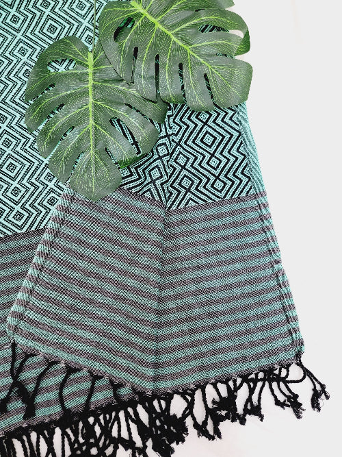 Striped towel with black tassels on a white background
