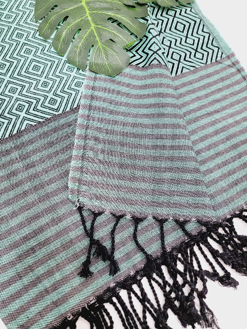 Striped towel with tassels on a patterned surface