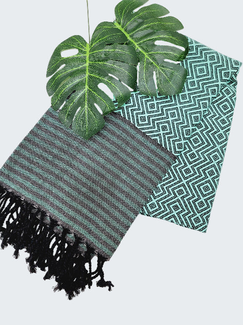 Two patterned cloths with green leaves on a white background