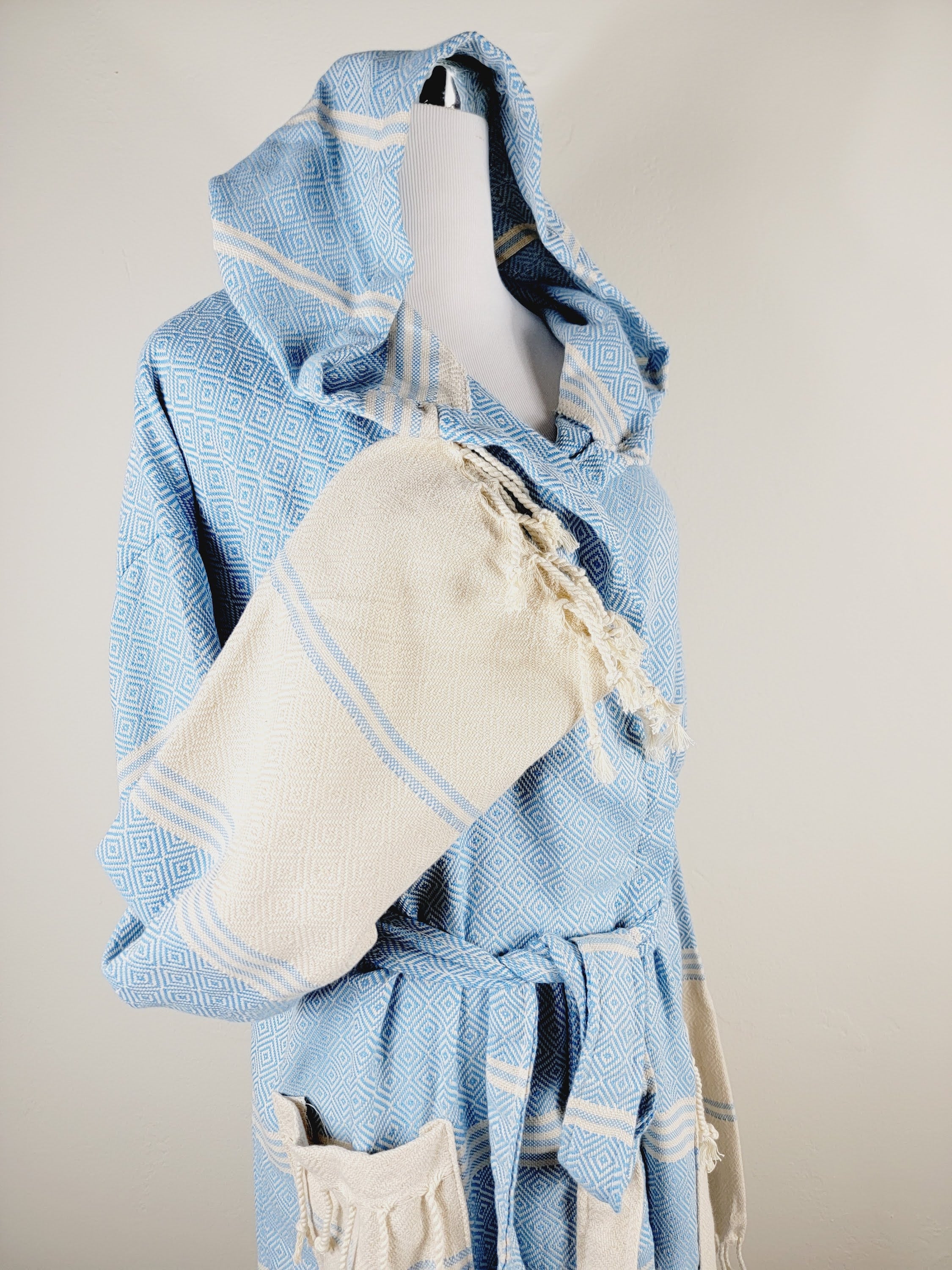 Blue and white textured robe with a matching pouch on a mannequin against a neutral background