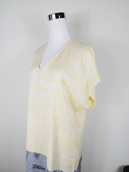 Mannequin wearing a light yellow tie-dye shirt against a plain background