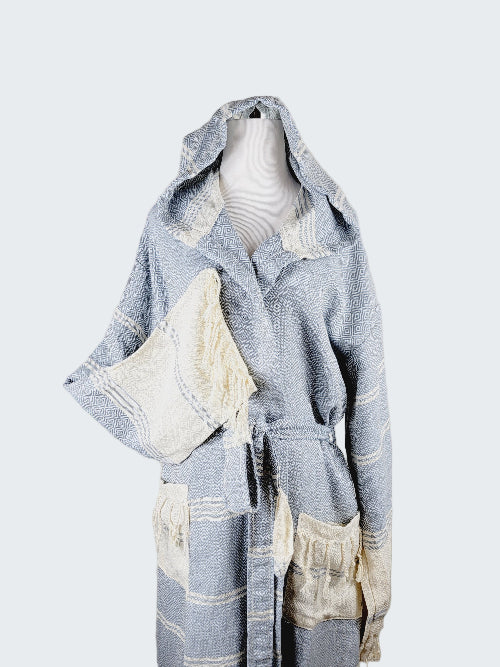 Blue and white hooded robe with a pillow on a mannequin against a plain background