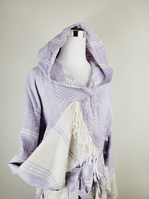 Lavender and white hooded towel on a mannequin against a neutral background