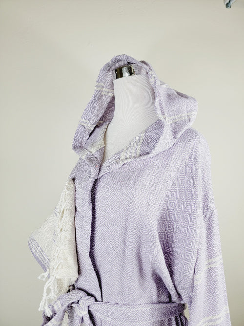 Lavender bathrobe with white geometric pattern on a mannequin against a plain background