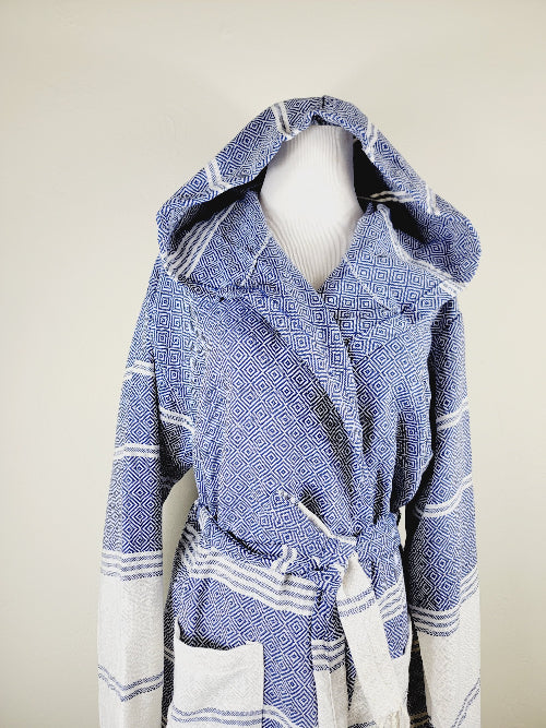 Blue and white patterned robe on a mannequin against a beige background