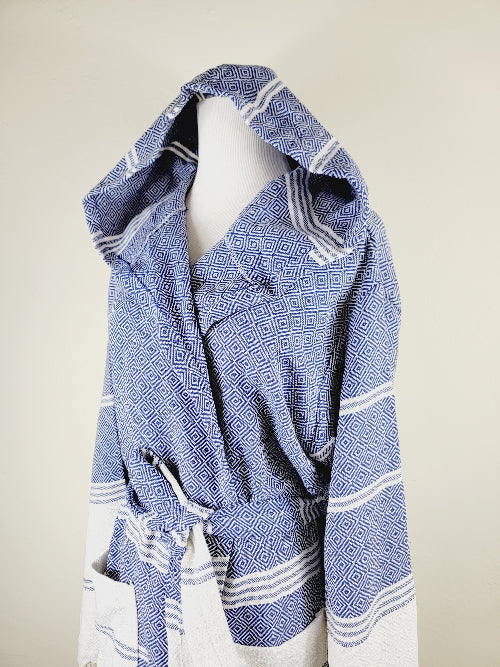 Blue and white patterned robe on a mannequin against a beige background