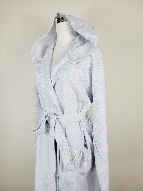 Light blue robe on a mannequin against a beige background
