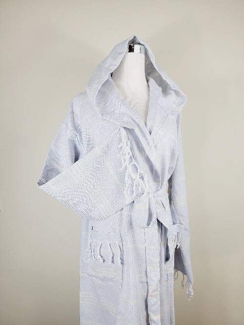 White bathrobe on a mannequin against a beige background
