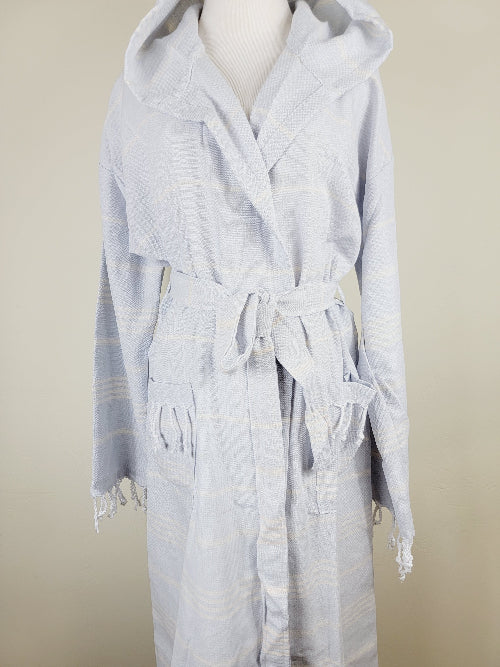 Light gray hooded robe with fringe details on a neutral background