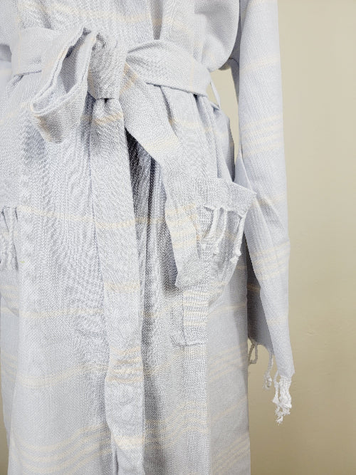 Light gray robe with striped pattern on a beige background