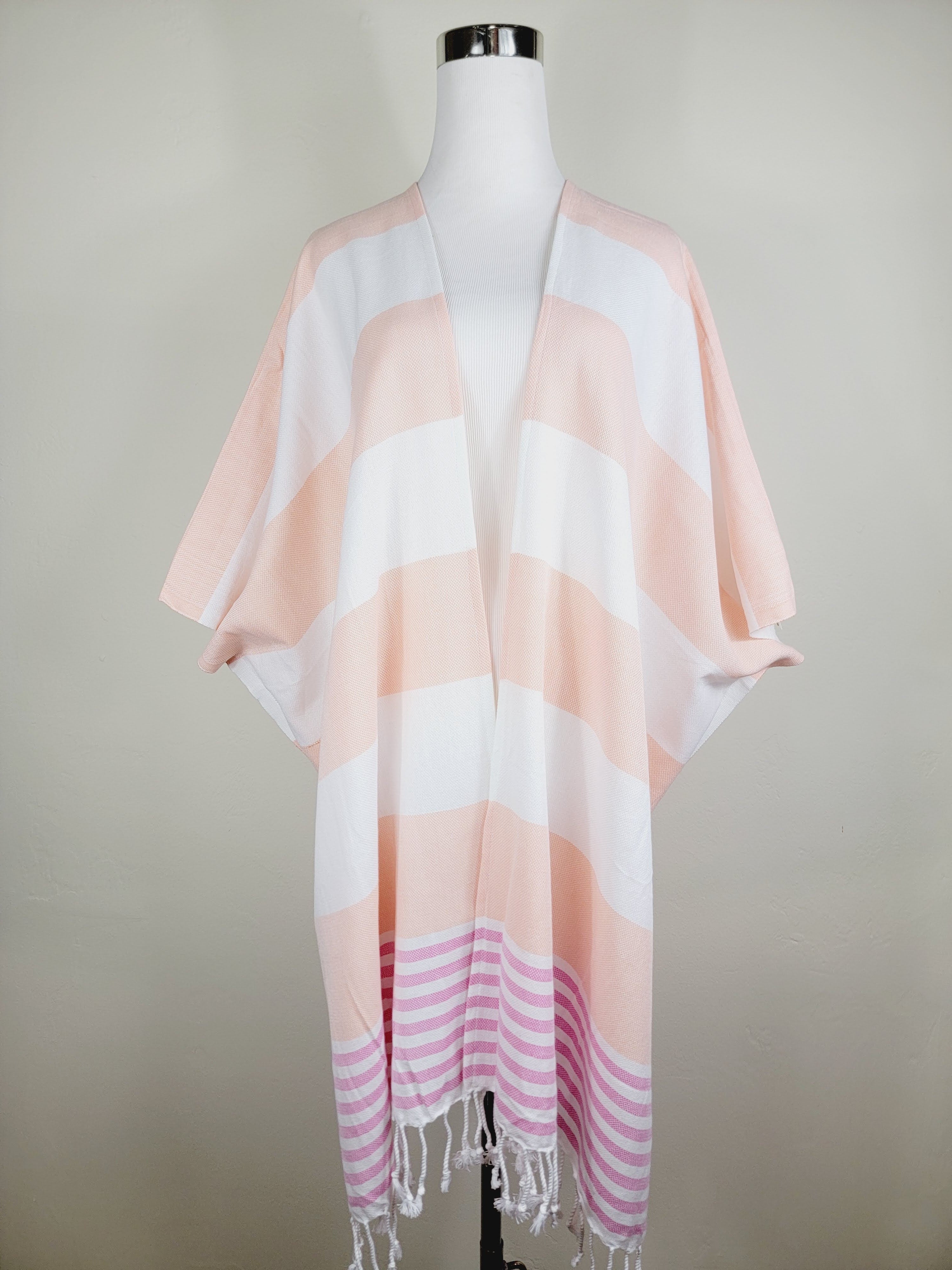 Striped pink and white scarf on a mannequin against a plain background