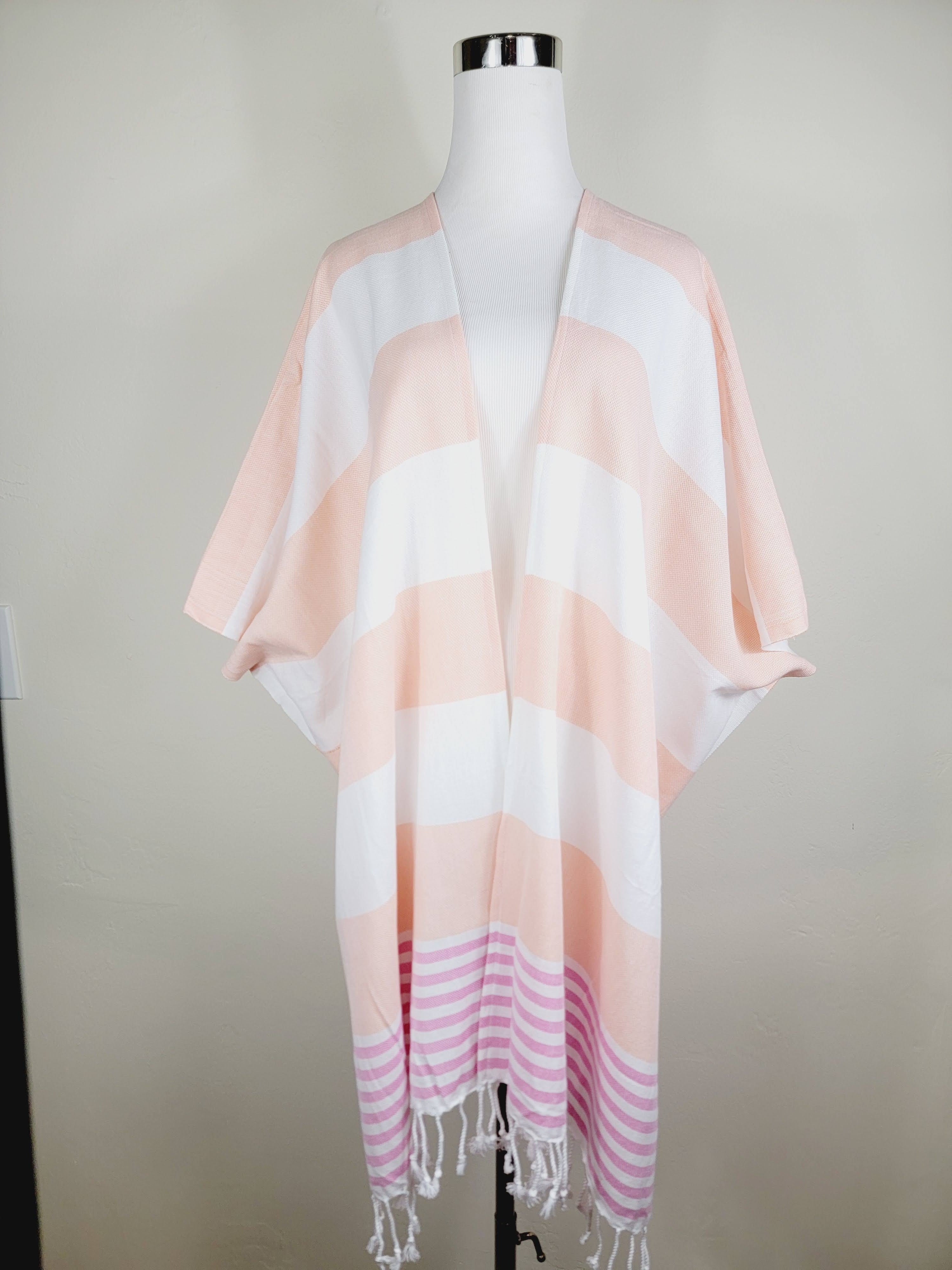 Striped scarf with pink and white colors on a mannequin against a neutral background