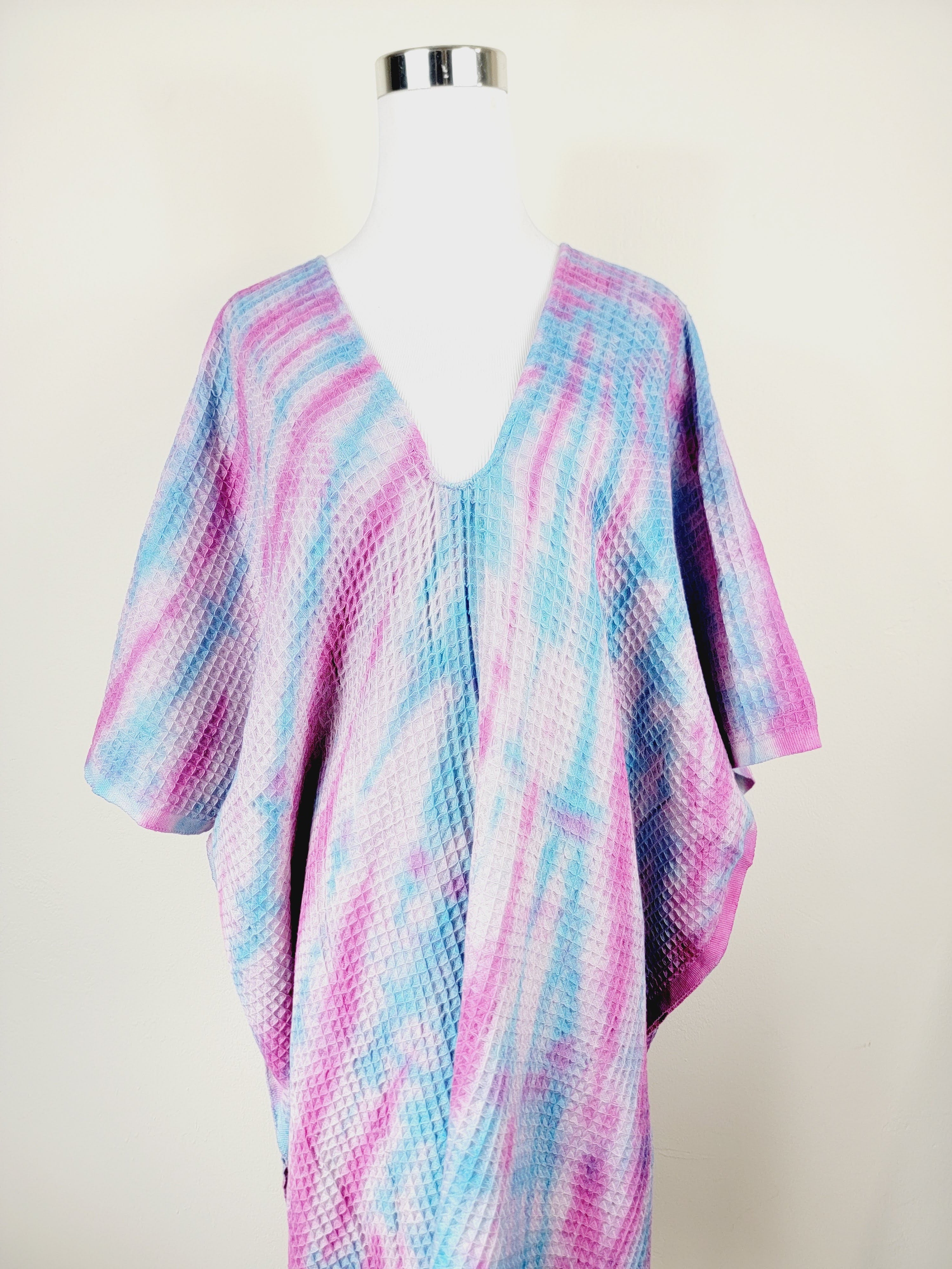 Colorful patterned garment on a mannequin against a white background