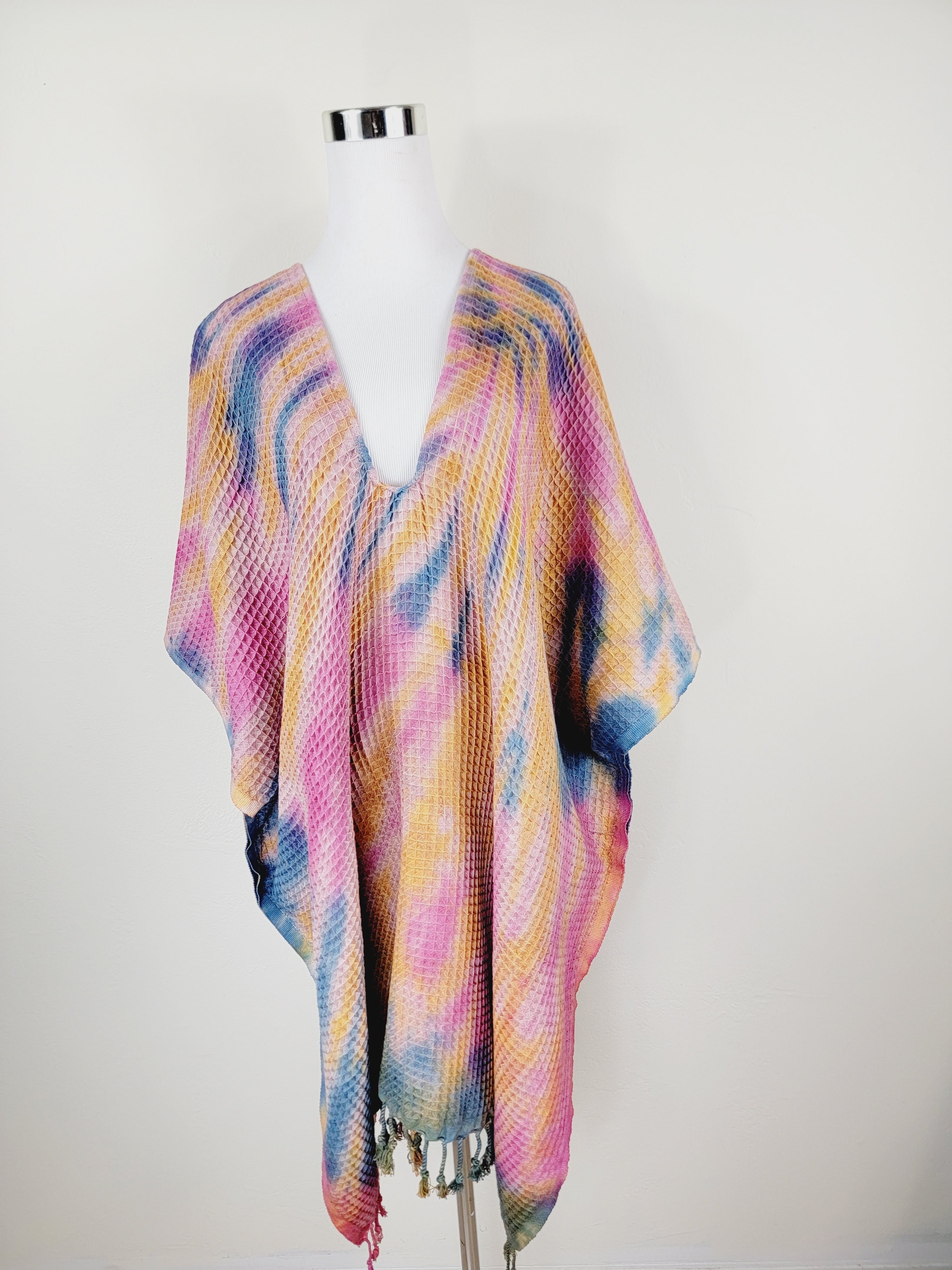 Colorful scarf on a mannequin against a white background