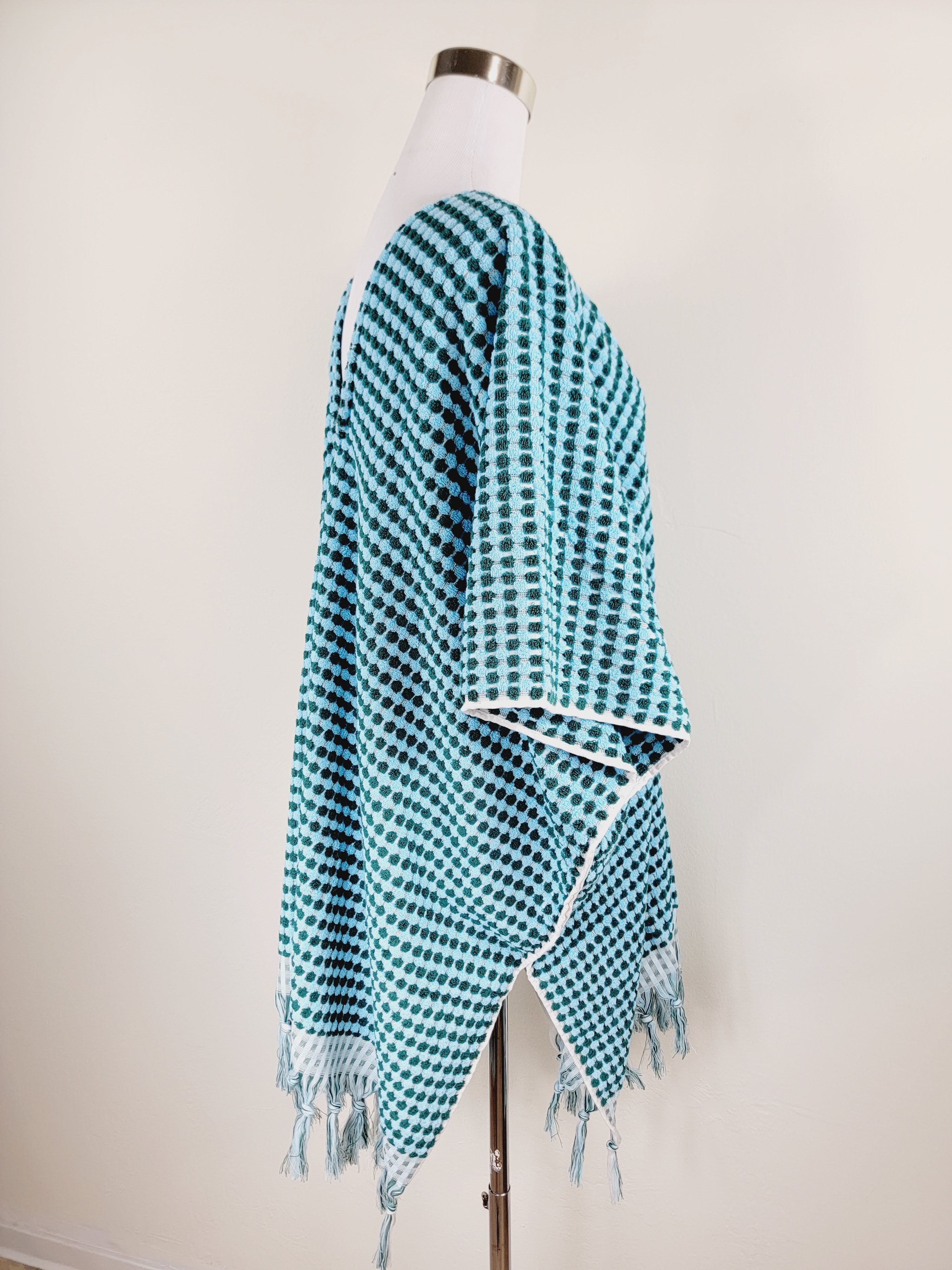 Blue and white checkered shawl on a mannequin against a white background