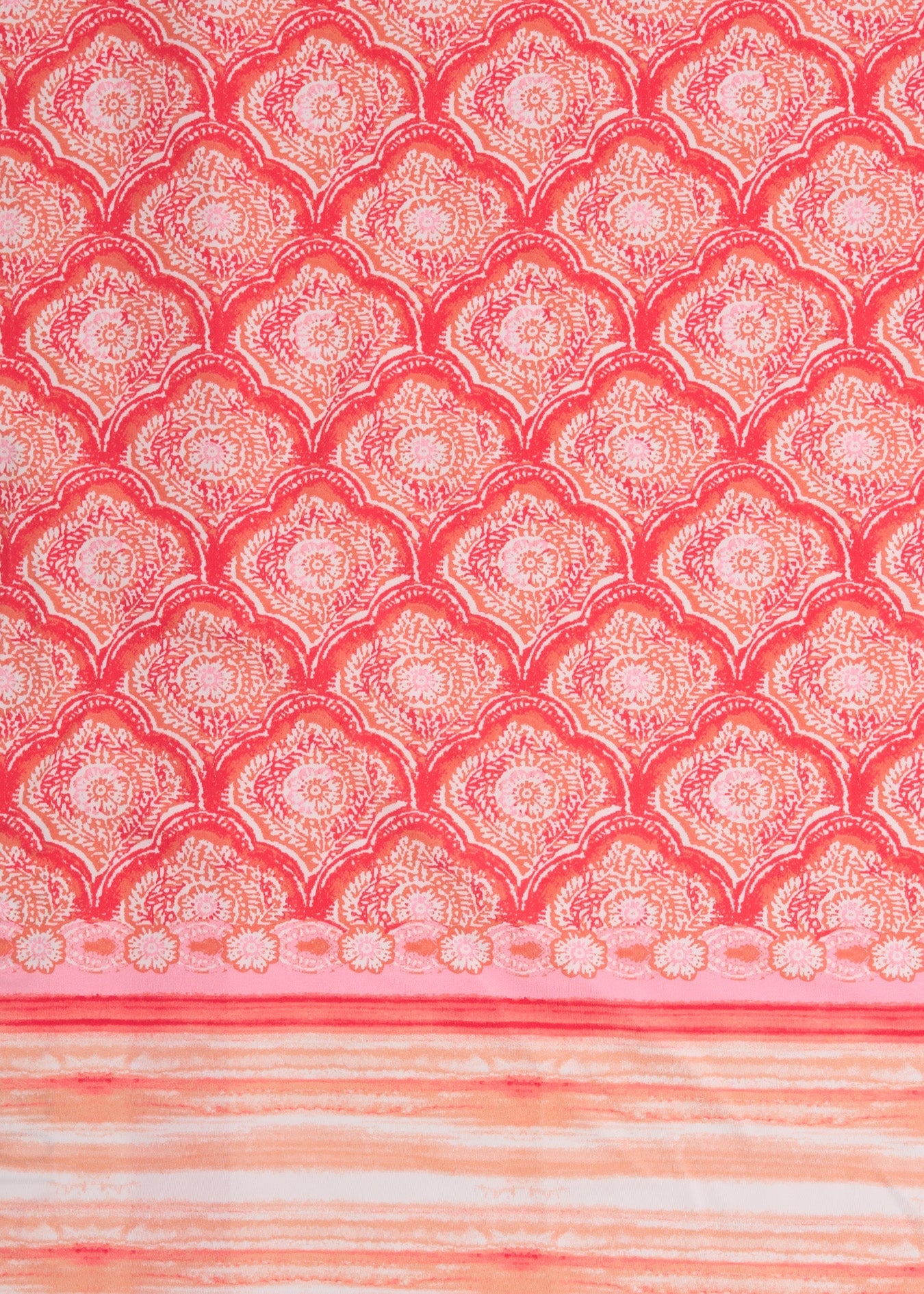 Patterned fabric with a geometric design in red and pink tones.