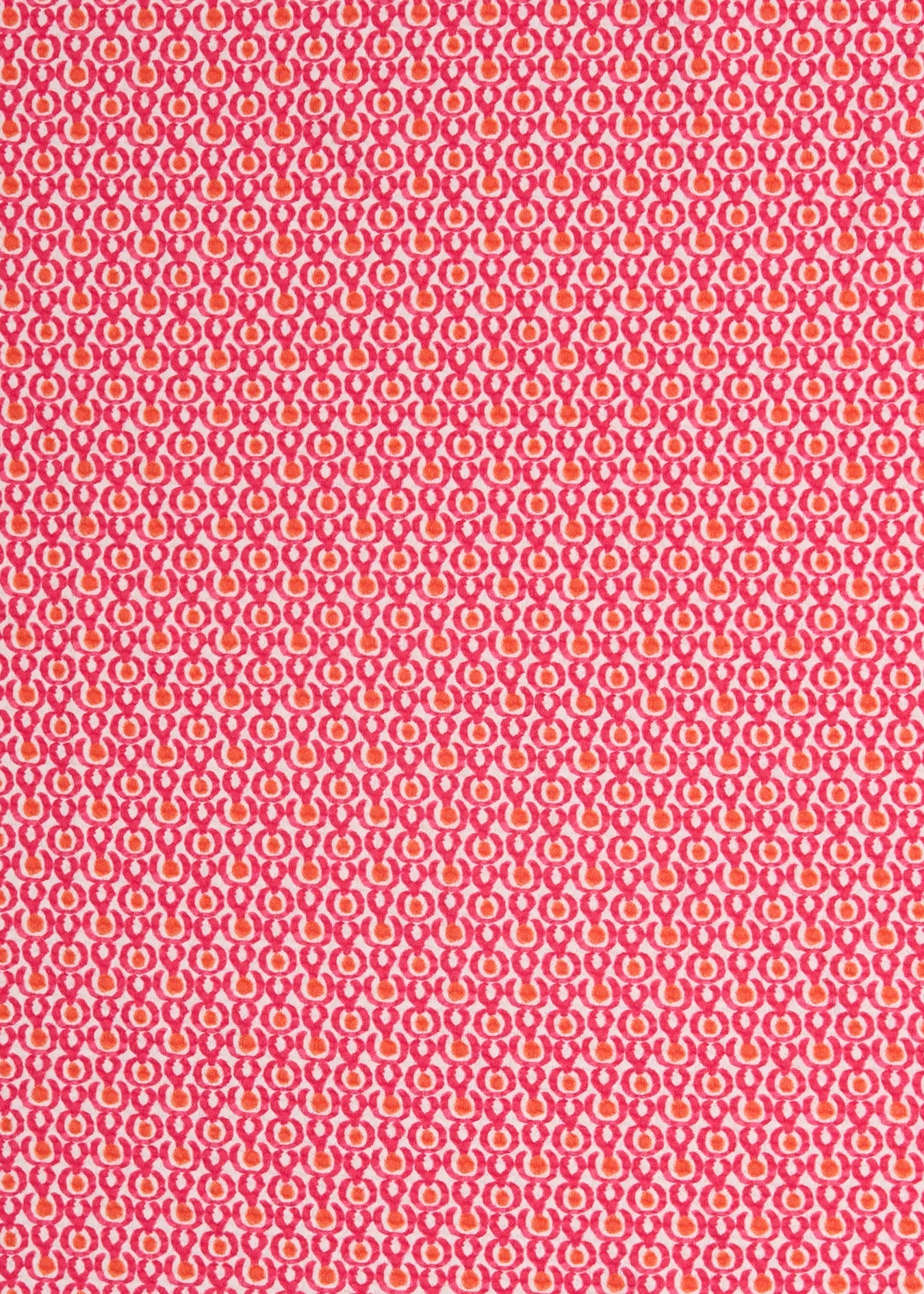 Patterned fabric with a small geometric design on a pink background