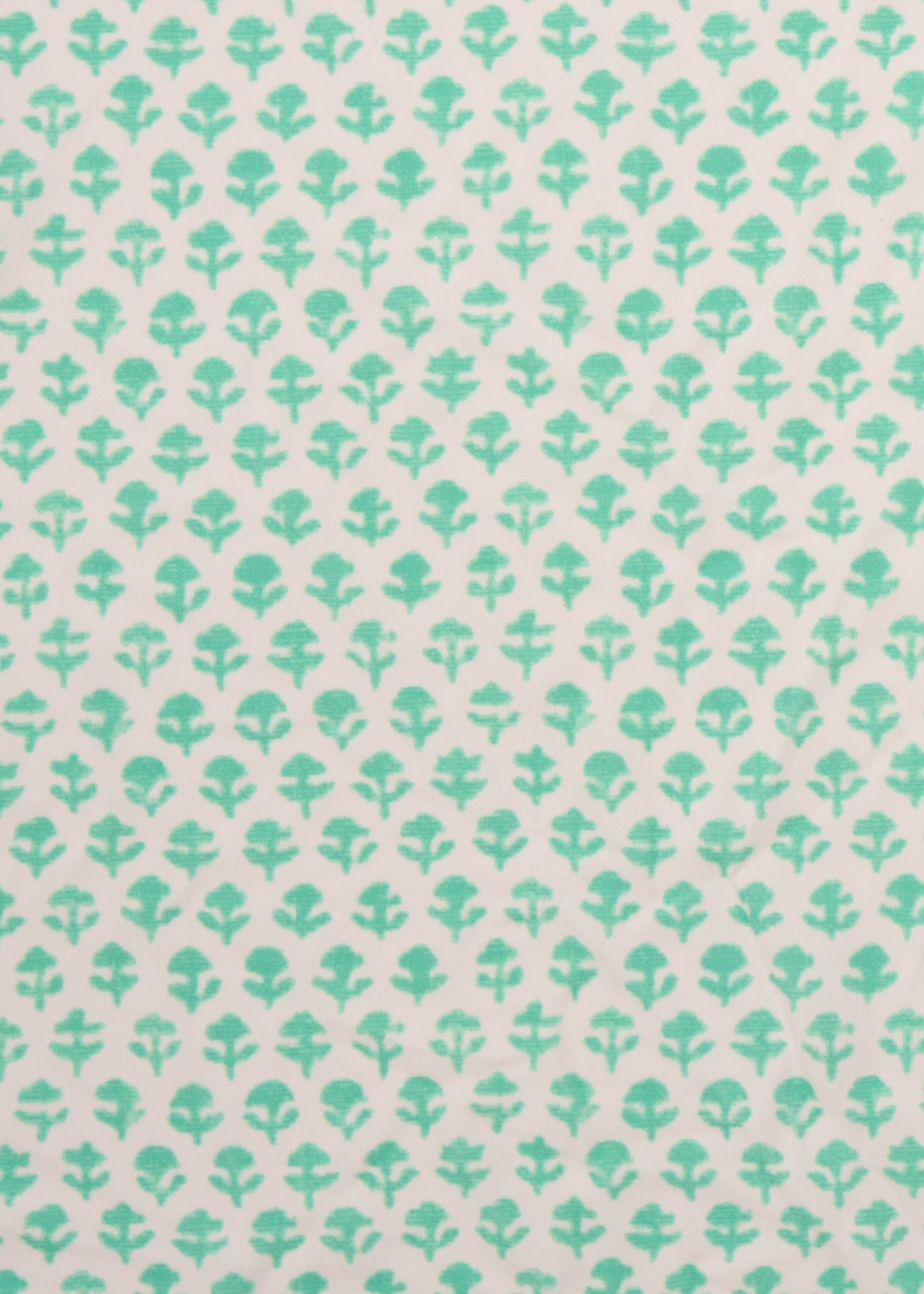 Pattern of green leaves on a light pink background