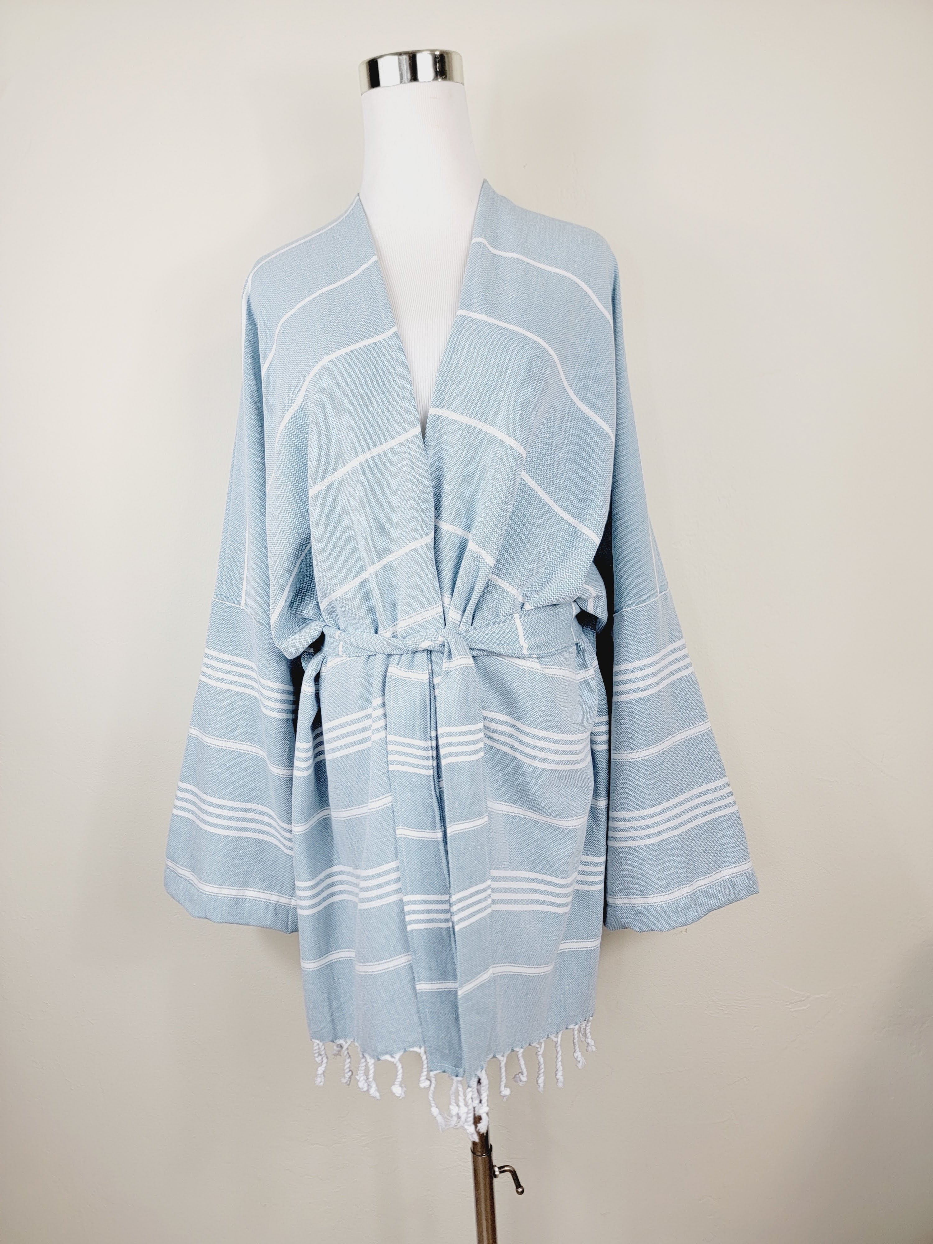 Light blue striped kimono-style garment on a mannequin against a plain background